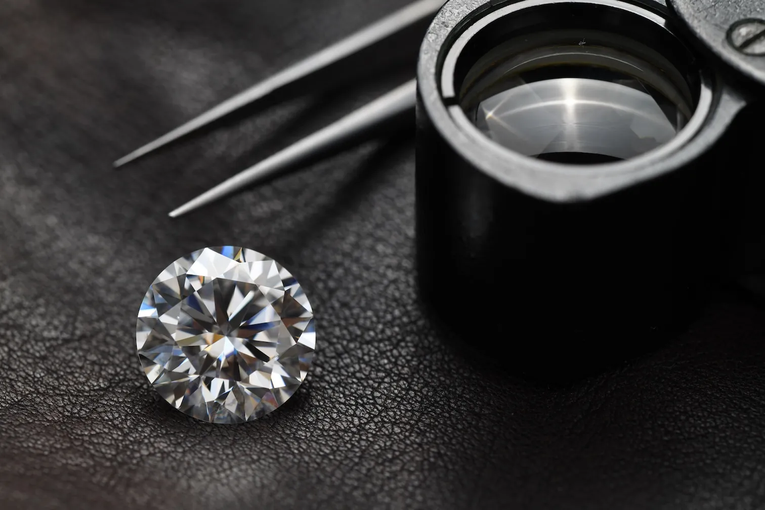 Diamond with tweezers and loupe